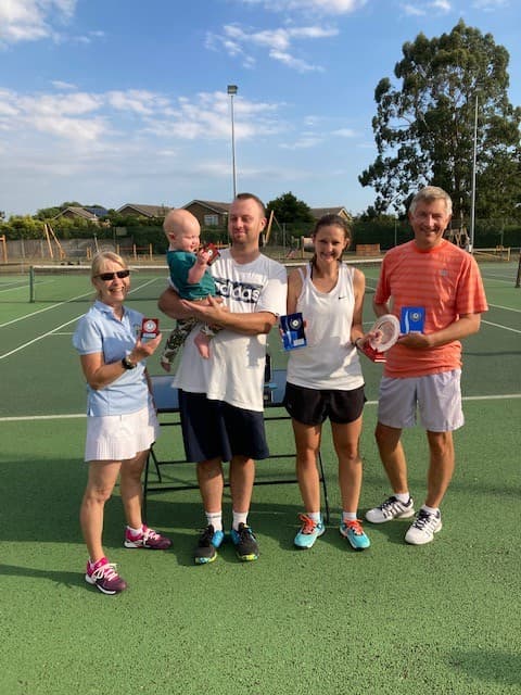 Members gathered beside the tennis courts