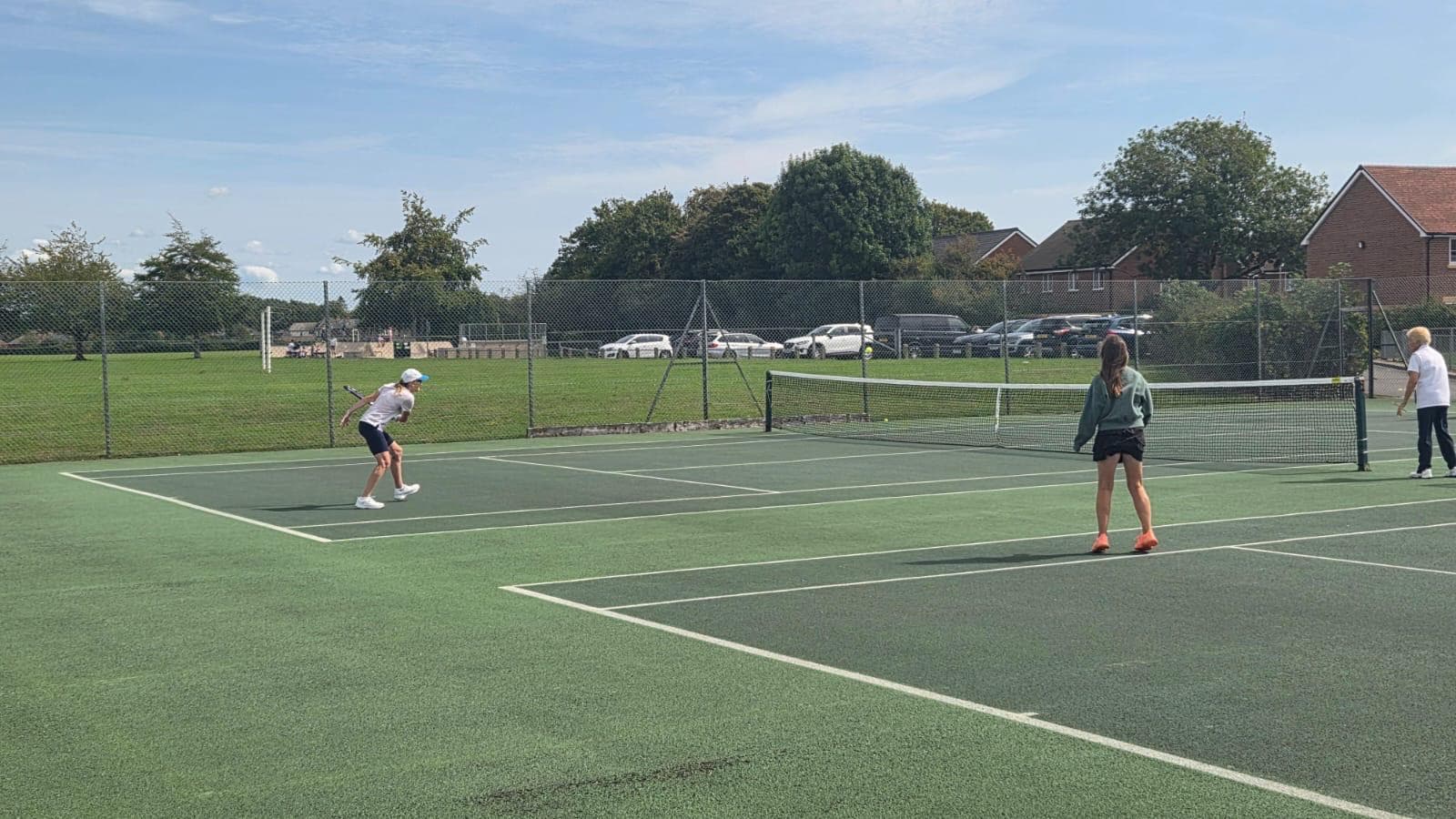 Group tennis coaching session